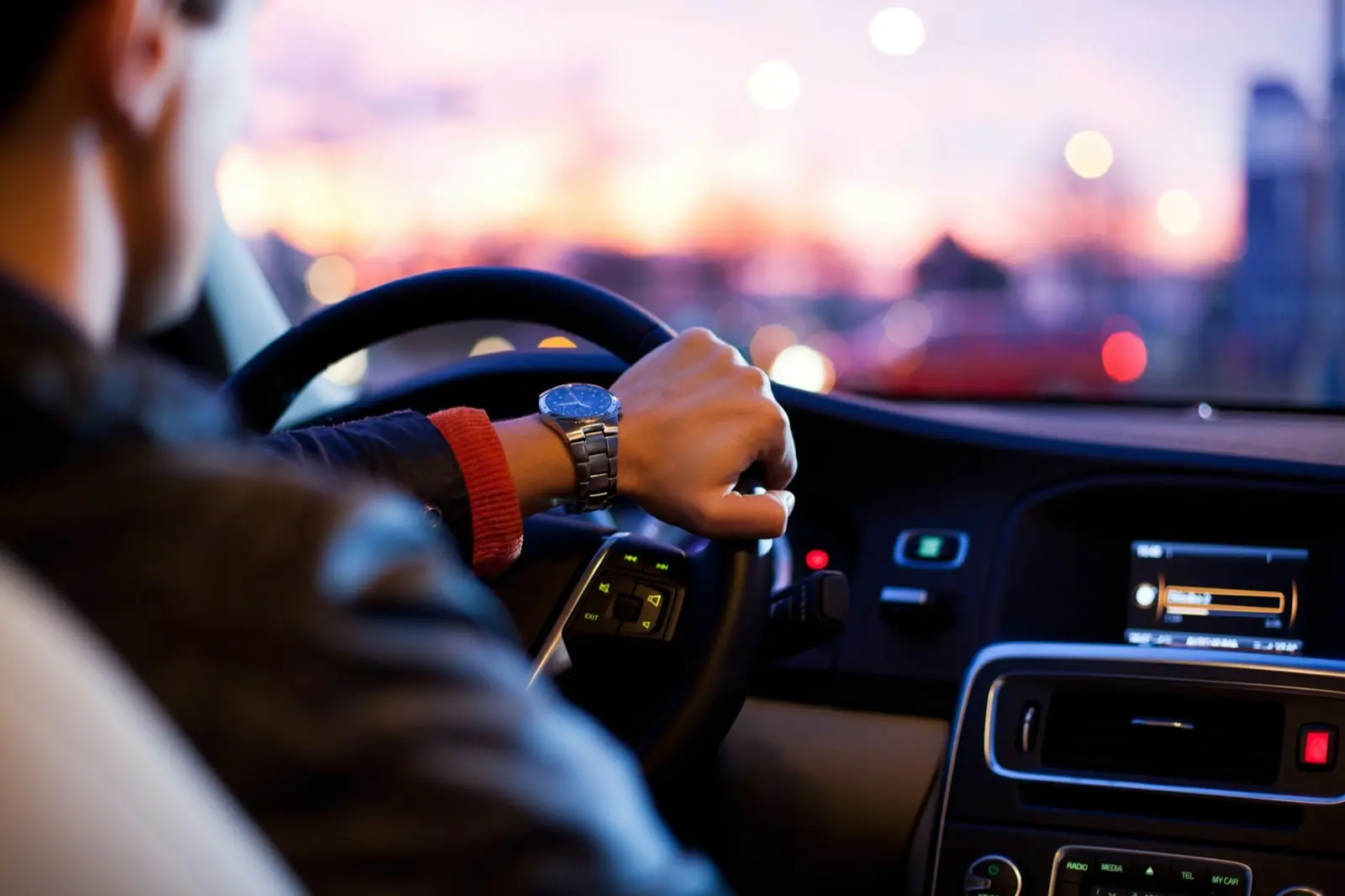 Driver's hands on the steering wheel